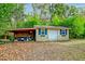 Yellow storage shed with blue shutters and covered workspace at 185 Old Fort Dr, Ladson, SC 29456