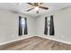 Spacious bedroom with ceiling fan, wood-look flooring, and two windows at 1979 Macon Ave, North Charleston, SC 29405
