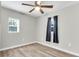 Bright bedroom with ceiling fan, wood-look flooring and window coverings at 1979 Macon Ave, North Charleston, SC 29405