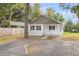 Charming white cottage with wood accents and a gravel driveway at 1979 Macon Ave, North Charleston, SC 29405