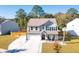 Two-story house with gray siding, white garage door, and landscaped yard at 2009 Elvington Rd, Johns Island, SC 29455
