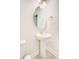 Stylish powder room, featuring a pedestal sink and oval mirror at 2009 Elvington Rd, Johns Island, SC 29455