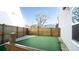 Artificial turf side yard with wood fence and stone border at 2009 Elvington Rd, Johns Island, SC 29455