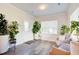 Sunroom with hardwood floors, white door, and abundant plants at 2009 Elvington Rd, Johns Island, SC 29455
