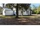 Side view of a white cottage with black accents and a large yard at 203 Padgett Loop, Walterboro,  29488