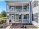 Two-story porch with white railings, columns, and outdoor furniture at 224 Berwick Dr, Summerville,  29483