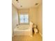 Bathroom with a bathtub, toilet, and a window for natural light at 2326 Daniel Island Dr, Charleston, SC 29492