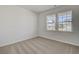 Well-lit bedroom with neutral carpeting and two windows at 245 Pine Crest View Dr, Summerville,  29486