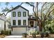 White two-story house with dark trim, a large tree, and landscaping at 2715 Old Oak Walk, Seabrook Island,  29455