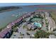Aerial view of community with pool, tennis court, and marina at 30 Mariners Cay Dr, Folly Beach, SC 29439