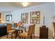Small dining area with glass table and four chairs, featuring artwork on the walls at 30 Mariners Cay Dr, Folly Beach, SC 29439
