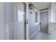 Private entryway with white door and gray siding at 30 Mariners Cay Dr, Folly Beach, SC 29439
