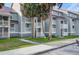 Gray multi-unit building with white trim, balconies, and palm trees at 30 Mariners Cay Dr, Folly Beach,  29439