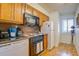 Bright kitchen with white appliances and wood cabinets at 30 Mariners Cay Dr, Folly Beach, SC 29439