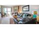 Living room with black leather couch and fireplace, offering water views at 30 Mariners Cay Dr, Folly Beach, SC 29439