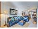 Living room with blue leather couch and chairs, offering view into dining area at 30 Mariners Cay Dr, Folly Beach, SC 29439