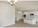 Open concept kitchen and dining area with white cabinets and hardwood floors at 307 Quiet Cove Trl, Summerville,  29486