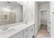 Double vanity bathroom with white cabinets, quartz countertops and a large mirror at 316 Calm Water Way, Summerville, SC 29486
