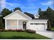 Charming one-story home with white siding, a dark brown door, and a two-car garage at 316 Calm Water Way, Summerville, SC 29486