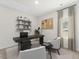 Home office with a black desk, floating shelves, and two comfortable armchairs at 316 Calm Water Way, Summerville, SC 29486