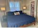 King bedroom with dark blue comforter and ensuite bathroom at 3605 Bay Point Dr, Edisto Island,  29438