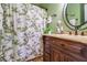 Charming bathroom with a wooden vanity and decorative shower curtain at 4415 Lord Proprietors Rd, Hollywood, SC 29449