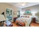 Cozy bedroom with hardwood floors, large windows, and a comfortable bed at 4415 Lord Proprietors Rd, Hollywood, SC 29449