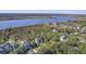 Aerial view of a waterfront community featuring several houses and lush greenery at 4629 Bonnie Marie Way, North Charleston,  29405