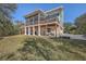 Two-story house with a large deck, screened porch, and golf cart parking at 4629 Bonnie Marie Way, North Charleston,  29405