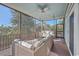 Relaxing screened porch with wicker furniture and a ceiling fan at 4629 Bonnie Marie Way, North Charleston,  29405