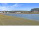 Expansive backyard with pond view and grassy area at 488 Sanctuary Park Dr, Summerville, SC 29486