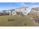 Spacious backyard with a large grassy area, garden beds, and a pergola-covered patio at 488 Sanctuary Park Dr, Summerville, SC 29486