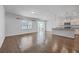 Open dining room and kitchen with hardwood floors and modern island at 488 Sanctuary Park Dr, Summerville, SC 29486