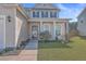 Two-story house with beige siding, white front door, and manicured lawn at 488 Sanctuary Park Dr, Summerville, SC 29486
