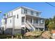 Two-story white home with a wrap-around porch and white railings at 619 Carolina Blvd, Isle of Palms,  29451