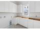 Laundry room with white cabinets and a window at 619 Carolina Blvd, Isle of Palms,  29451