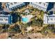 Aerial view of a resort-style pool surrounded by tropical landscaping and walkways at 7600 Palmetto Dr # C117, Isle of Palms,  29451