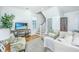 Bright living room with hardwood floors, comfortable seating, and a large TV at 8 Simons St, Charleston, SC 29403