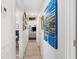 Bright hallway with artwork and view into living area at 825 Harbor View Rd, Charleston, SC 29412