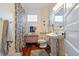 Updated bathroom with pedestal sink, shower, and vintage dresser at 103 Sw Railroad Ave, Saint George, SC 29477