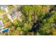 Aerial view of a two-story house with solar panels and a large backyard surrounded by trees at 1068 Blockade Runner Pkwy, Summerville, SC 29485