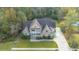 Aerial view of a two-story house with stone exterior, and a large backyard at 1068 Blockade Runner Pkwy, Summerville, SC 29485