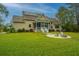 Large backyard with fire pit and home view at 1068 Blockade Runner Pkwy, Summerville, SC 29485