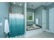 Bathroom features a walk-in shower, soaking tub, and teal accents at 1068 Blockade Runner Pkwy, Summerville, SC 29485