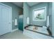 Spa-like bathroom with soaking tub, walk-in shower, and teal accents at 1068 Blockade Runner Pkwy, Summerville, SC 29485