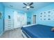 Bright bedroom with blue walls, a comfy bed, and French doors at 1068 Blockade Runner Pkwy, Summerville, SC 29485
