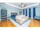 Bright bedroom with hardwood floors, large windows, and a comfy sitting area at 1068 Blockade Runner Pkwy, Summerville, SC 29485