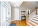 Bright entryway with hardwood floors, coat closet, and staircase at 1068 Blockade Runner Pkwy, Summerville, SC 29485