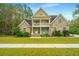 Two-story brick home with a front porch and grassy yard at 1068 Blockade Runner Pkwy, Summerville, SC 29485