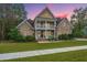 Two-story brick home with a front porch and landscaped yard at 1068 Blockade Runner Pkwy, Summerville, SC 29485